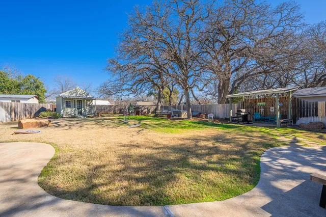 a view of swimming pool with outdoor seating and large trees
