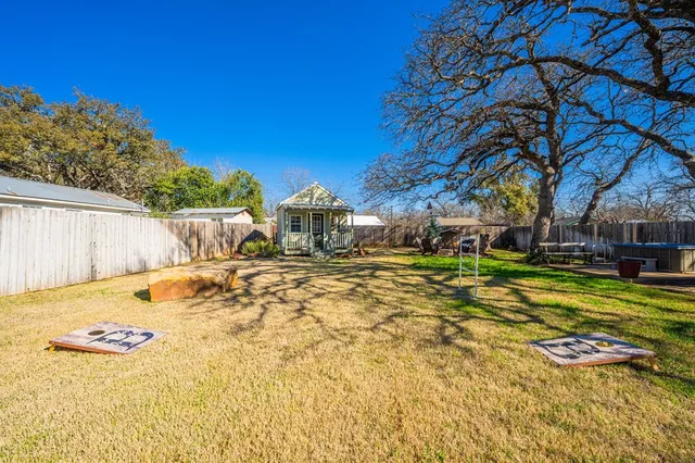 a view of a house with pool and sitting area
