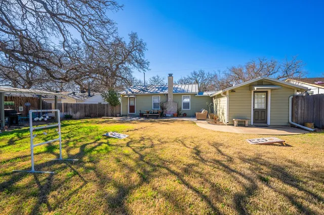 a swimming pool with outdoor seating and yard