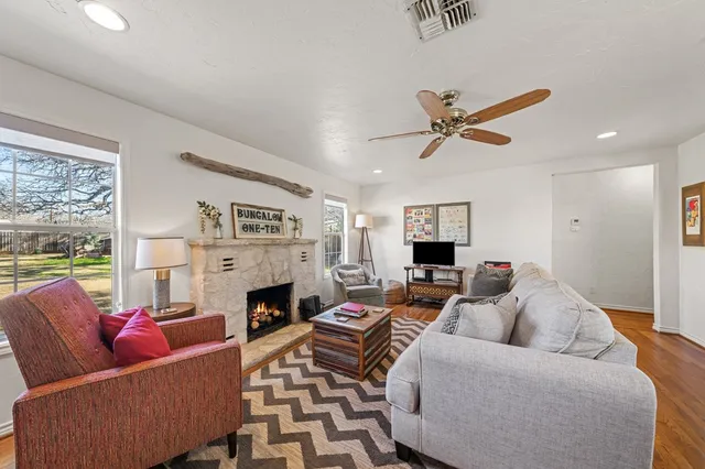 a living room with furniture a fireplace and a flat screen tv