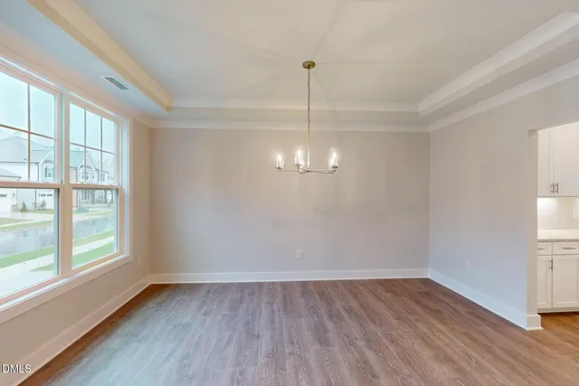 a kitchen with a sink window and cabinets