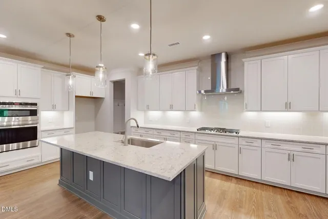 an empty room with windows and fireplace