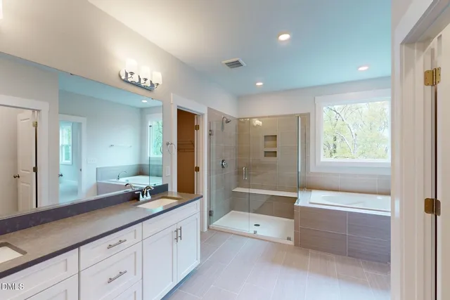 a bathroom with a double vanity sink and a mirror