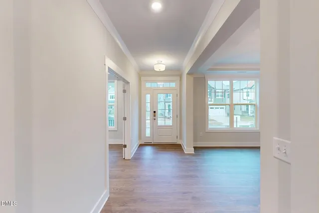 a view of a room with wooden floor chandeliers and window