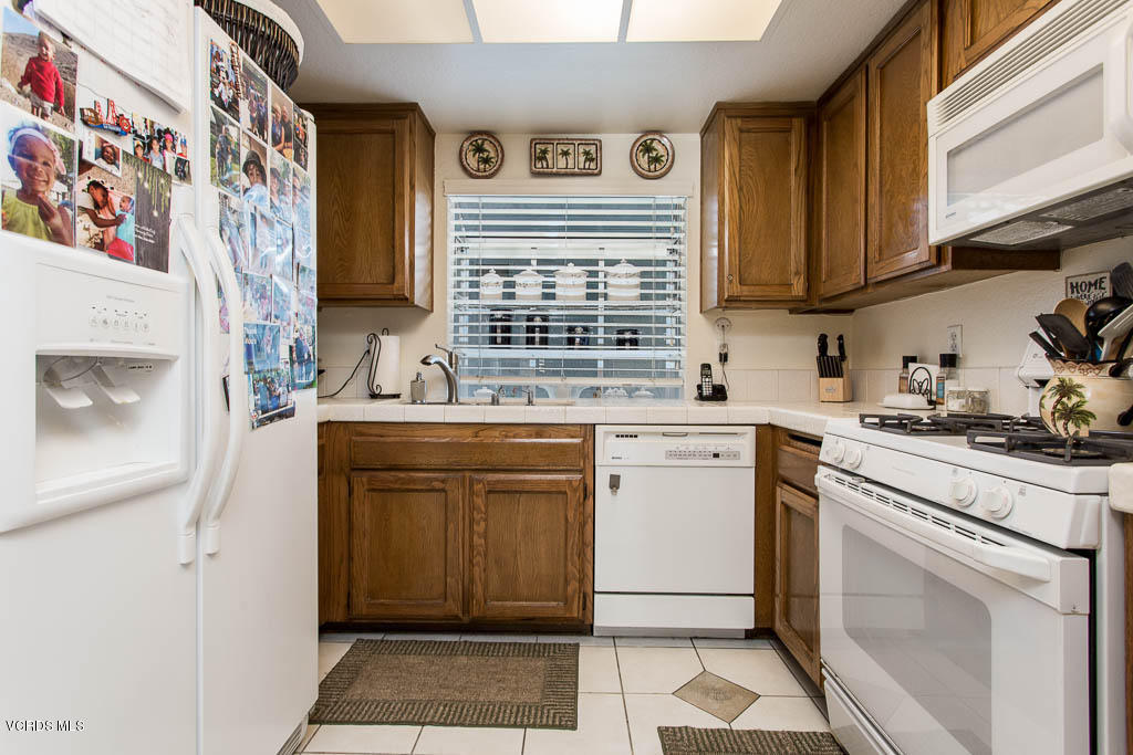 1818 Rory Lane, Unit 8 Simi Valley, CA 93063 - Photo 12 of 31 a kitchen with a sink stove and cabinets