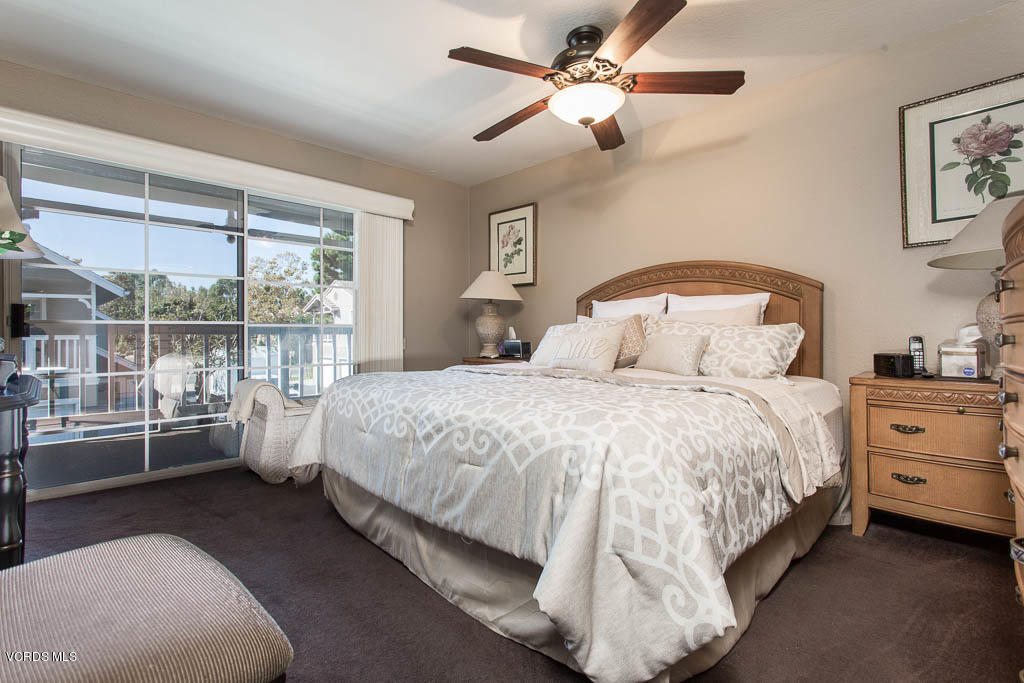 1818 Rory Lane, Unit 8 Simi Valley, CA 93063 - Photo 18 of 31 a bedroom with a large bed and a tv