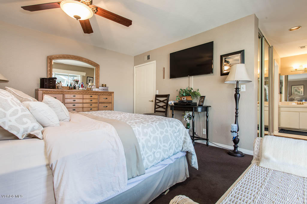 1818 Rory Lane, Unit 8 Simi Valley, CA 93063 - Photo 19 of 31 a bedroom with a bed and a flat tv screen on a dresser