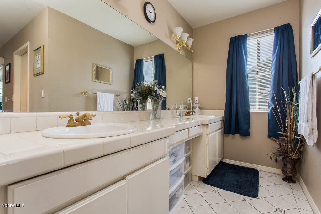 1818 Rory Lane, Unit 8 Simi Valley, CA 93063 - Photo 22 of 31 a bathroom with a sink a vanity and a mirror