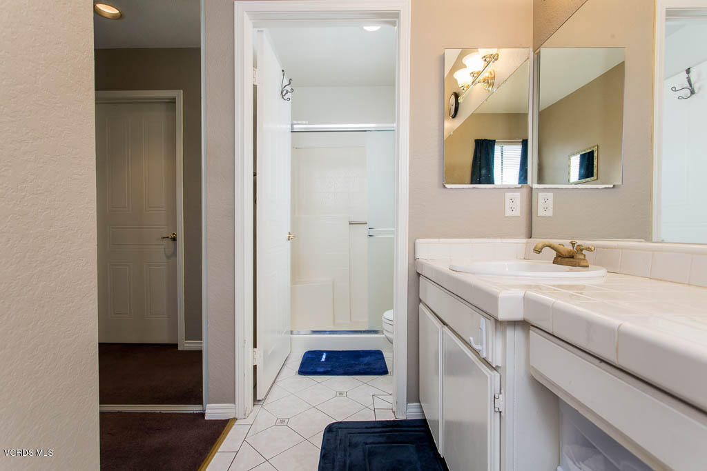 1818 Rory Lane, Unit 8 Simi Valley, CA 93063 - Photo 23 of 31 a bathroom with a sink and a mirror