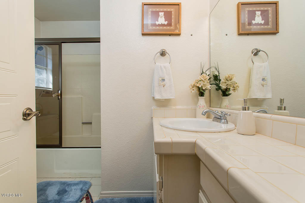 1818 Rory Lane, Unit 8 Simi Valley, CA 93063 - Photo 25 of 31 a bathroom with a sink and a mirror