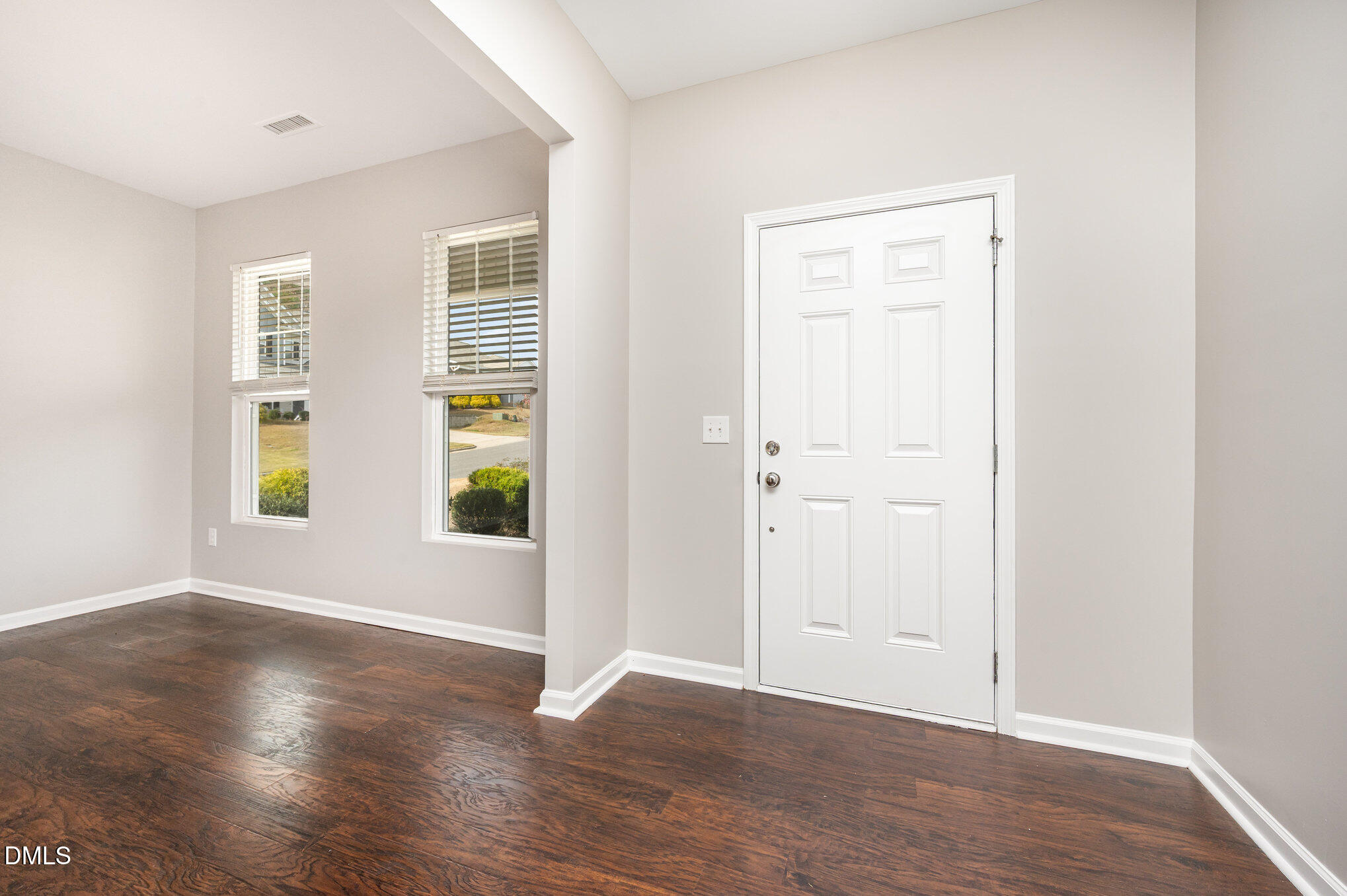 18 Dover Ridge Court Chapel Hill, NC 27517 - Photo 6 of 40 an empty room with wooden floor and windows