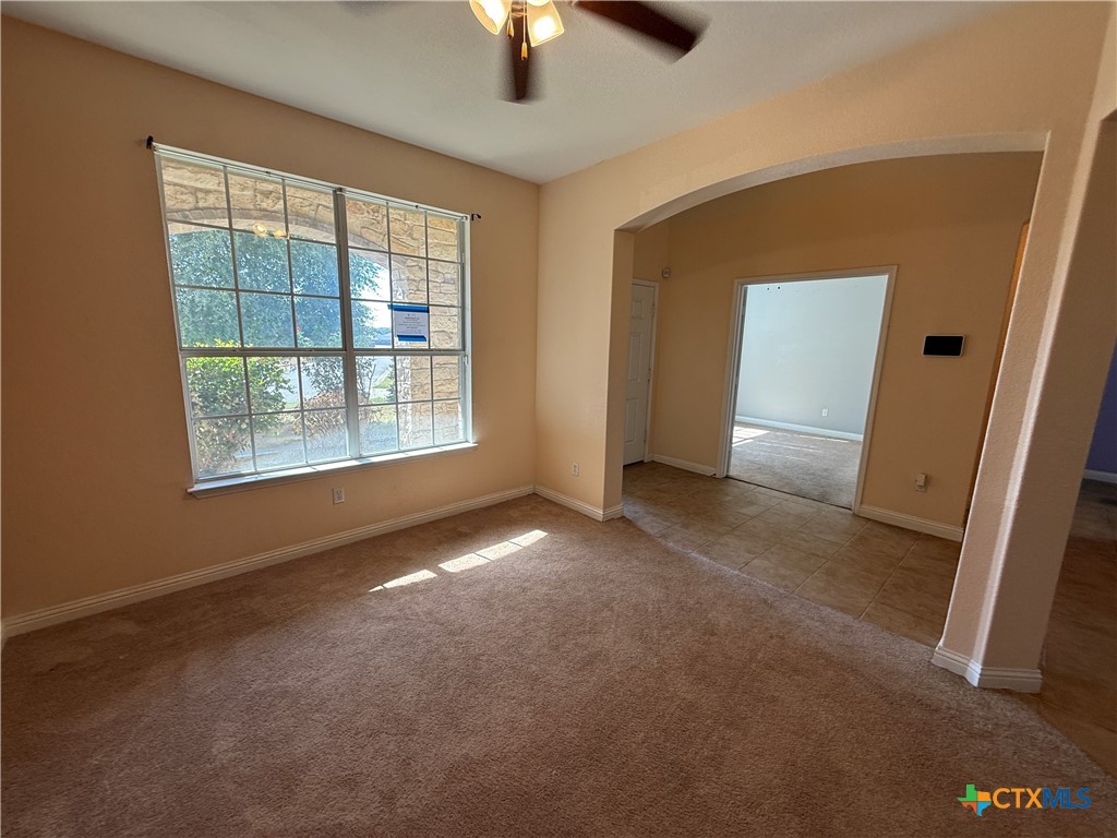 5607 Siltstone Loop Killeen, TX 76542 - Photo 13 of 48 an empty room with windows and chandelier fan
