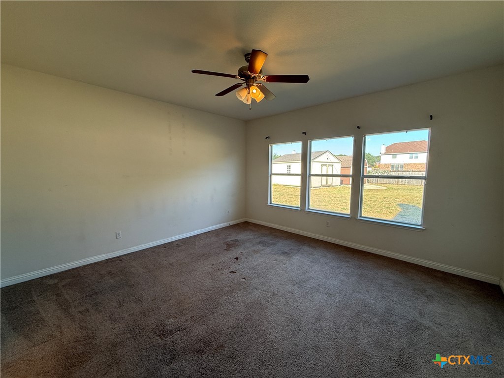 5607 Siltstone Loop Killeen, TX 76542 - Photo 16 of 48 an empty room with windows and ceiling fan