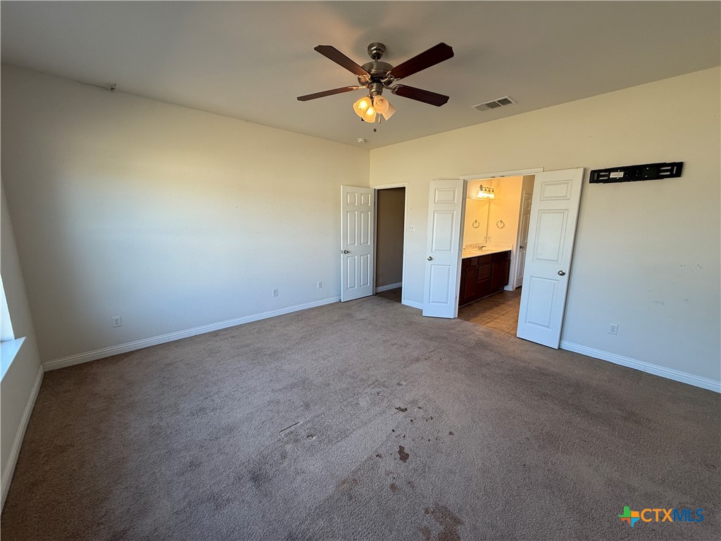 5607 Siltstone Loop Killeen, TX 76542 - Photo 18 of 48 an empty room with closet and a ceiling fan