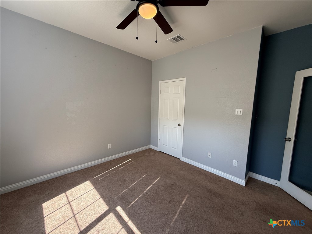 5607 Siltstone Loop Killeen, TX 76542 - Photo 23 of 48 an empty room with a ceiling fan and carpet