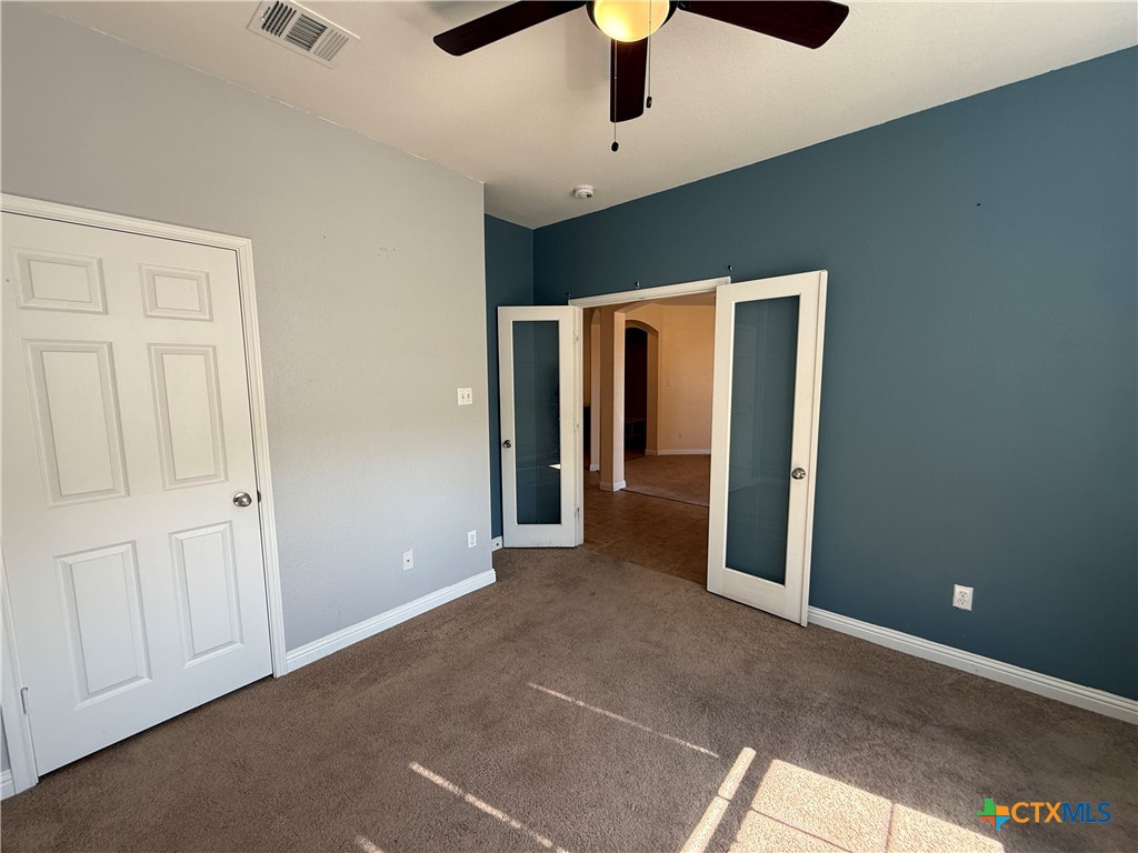 5607 Siltstone Loop Killeen, TX 76542 - Photo 24 of 48 an empty room with chandelier fan and hallway