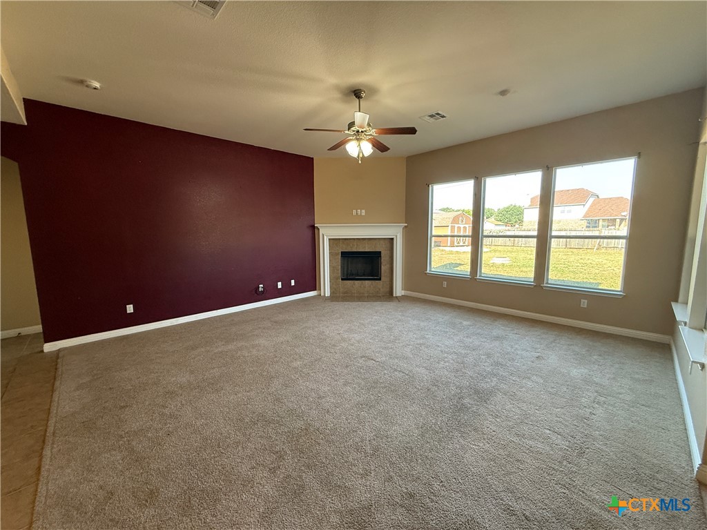 5607 Siltstone Loop Killeen, TX 76542 - Photo 6 of 48 an empty room with a fireplace and windows