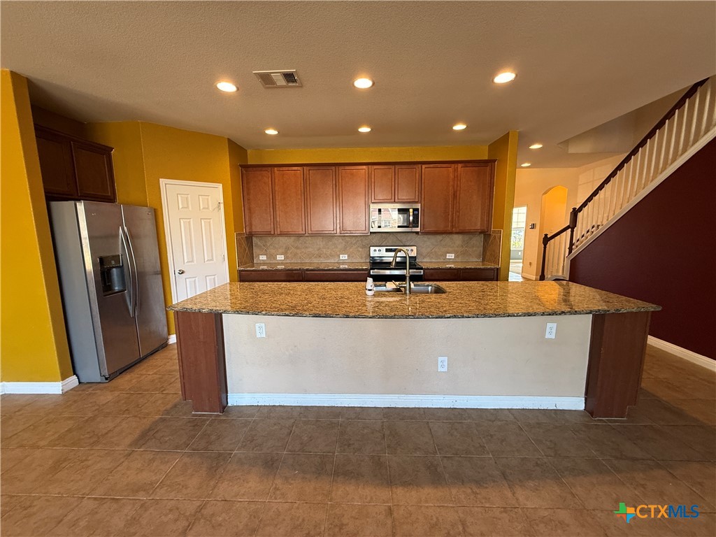 5607 Siltstone Loop Killeen, TX 76542 - Photo 8 of 48 a view of kitchen with stainless steel appliances granite countertop refrigerator sink and stove