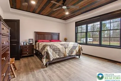 a bedroom with a bed and a large window