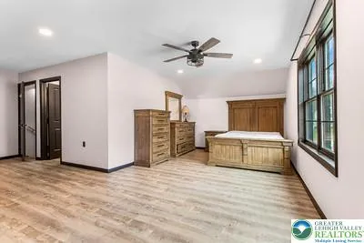 a spacious bedroom with a bed and a chandelier