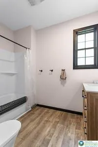 a view of a room with wooden floor and cabinet