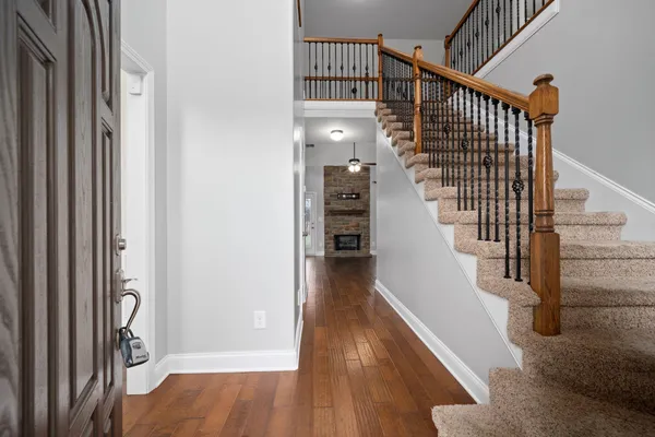 a view of entryway and hall with wooden floor