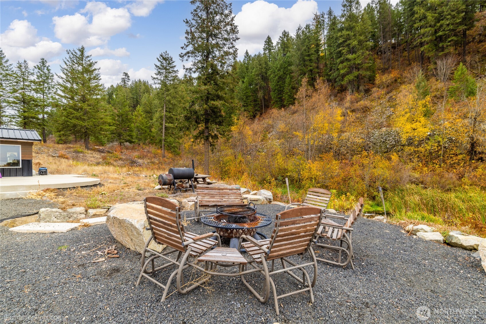8 Camden Road Elk, WA 99009 - Photo 4 of 29 a view of a backyard with table and chairs with wooden fence