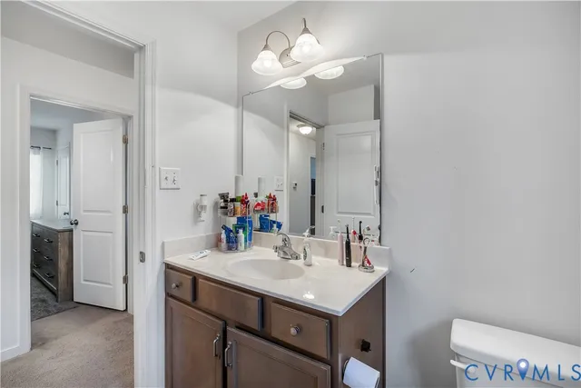 a bathroom with a sink vanity and a mirror
