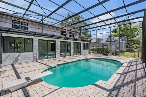 a view of a backyard with a swimming pool