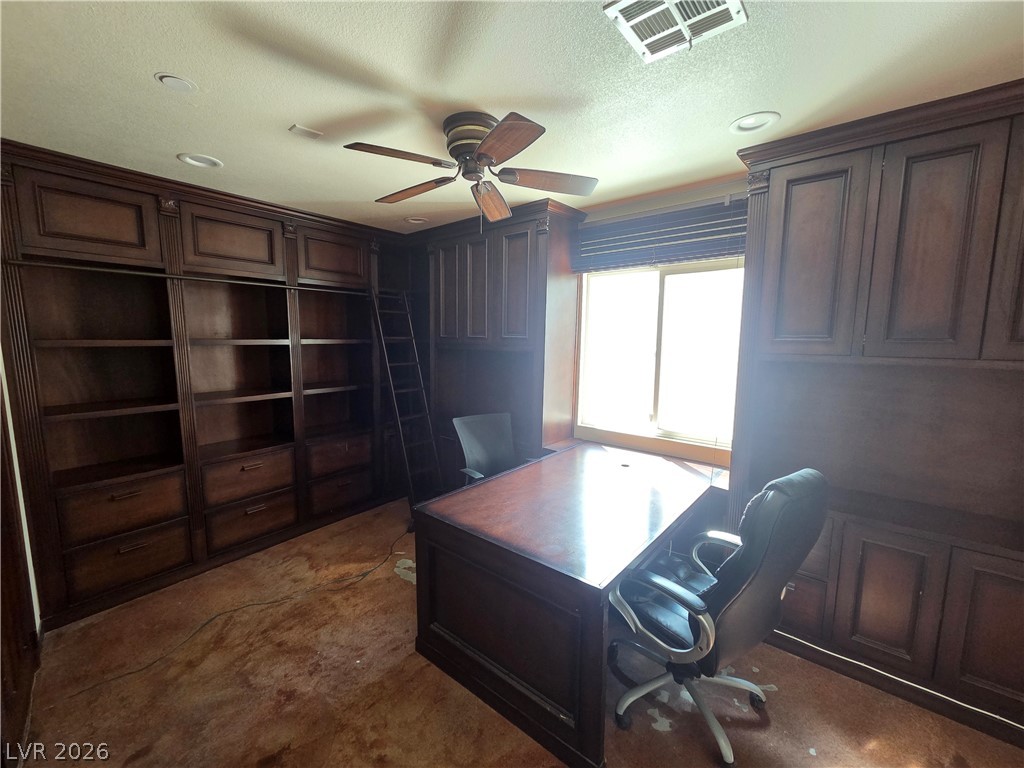 3381 Westwind Road Las Vegas, NV 89146 - Photo 35 of 52 A refined home office with extensive built-in cabinetry provides an ideal work-from-home setting.