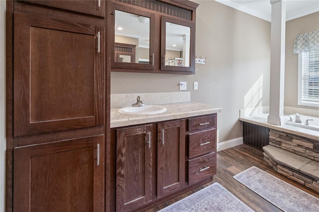 129 Perry Road, Unit 1 Hawthorne, FL 32640 - Photo 23 of 58 a bathroom with a sink a mirror and a window