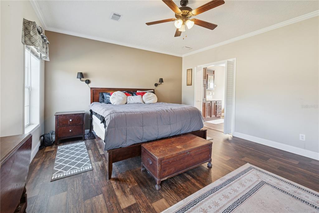 129 Perry Road, Unit 1 Hawthorne, FL 32640 - Photo 30 of 58 a bedroom with a bed and wooden floor