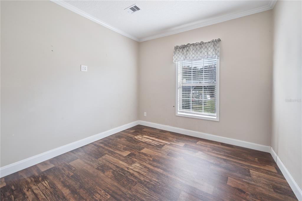 129 Perry Road, Unit 1 Hawthorne, FL 32640 - Photo 35 of 58 an empty room with wooden floor and windows