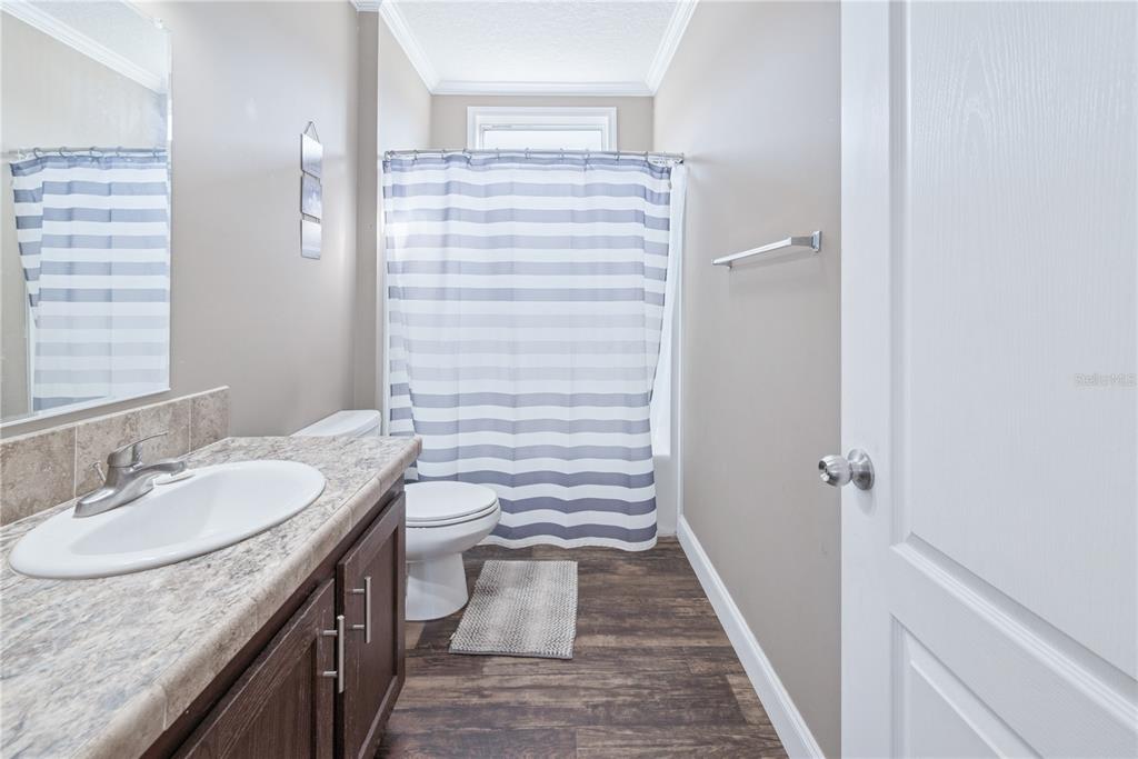 129 Perry Road, Unit 1 Hawthorne, FL 32640 - Photo 42 of 58 a bathroom with a granite countertop sink toilet and shower