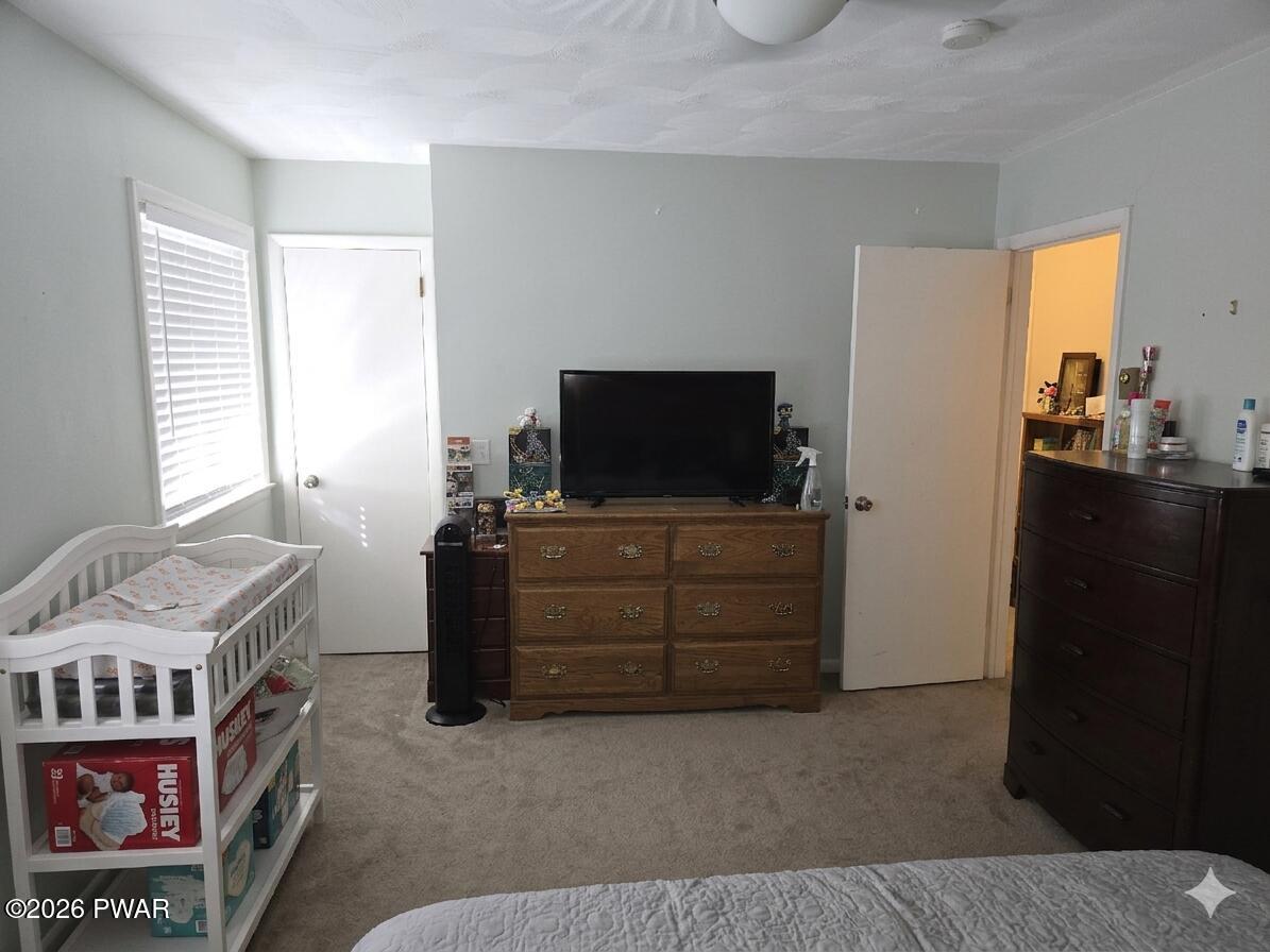 107 Keystone Hls Road, Unit 404 Factoryville, PA 18419 - Photo 9 of 23 a room with furniture and flat screen tv