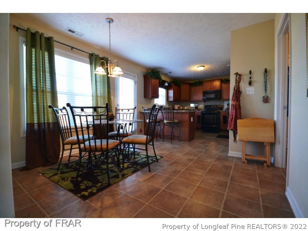 645 Cape Fear Road Raeford, NC 28376 - Photo 13 of 24 a view of a dining room with furniture window and outside view