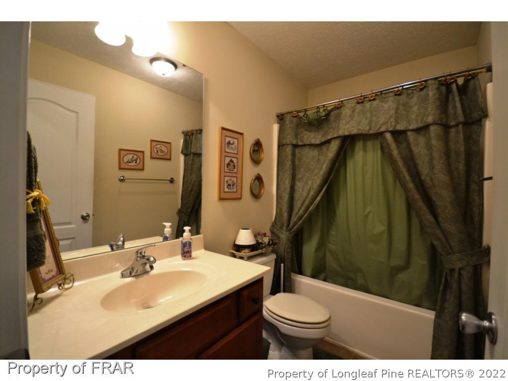 645 Cape Fear Road Raeford, NC 28376 - Photo 16 of 24 a bathroom with a sink vanity granite and a toilet