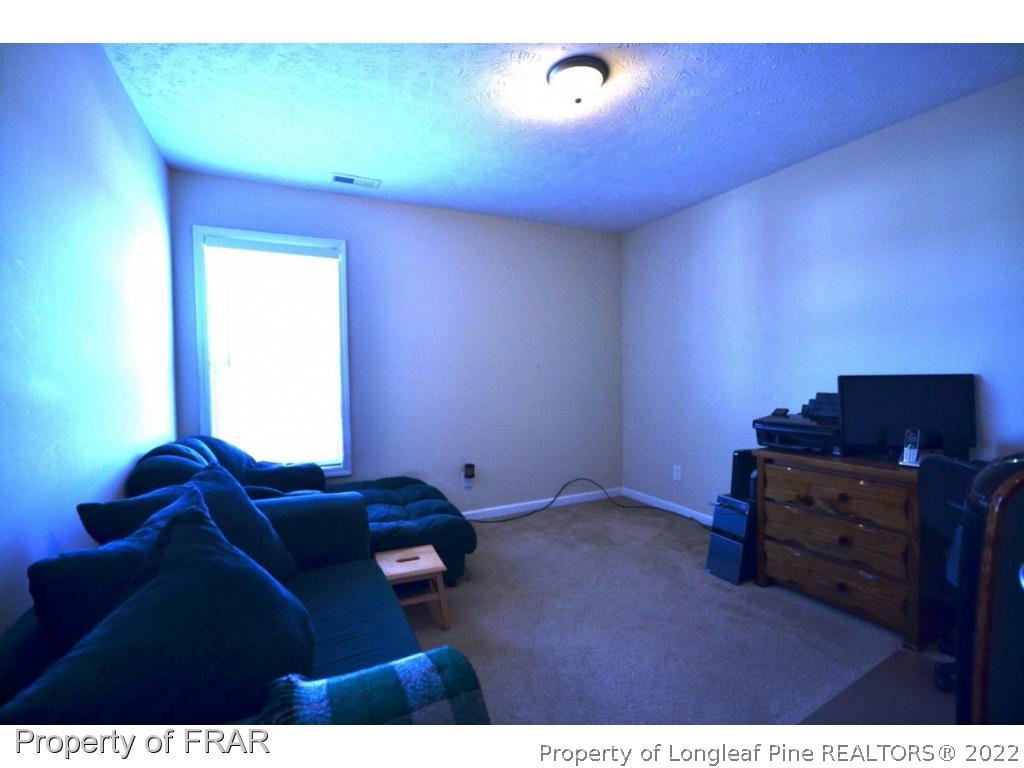 645 Cape Fear Road Raeford, NC 28376 - Photo 17 of 24 a living room with furniture and a flat screen tv