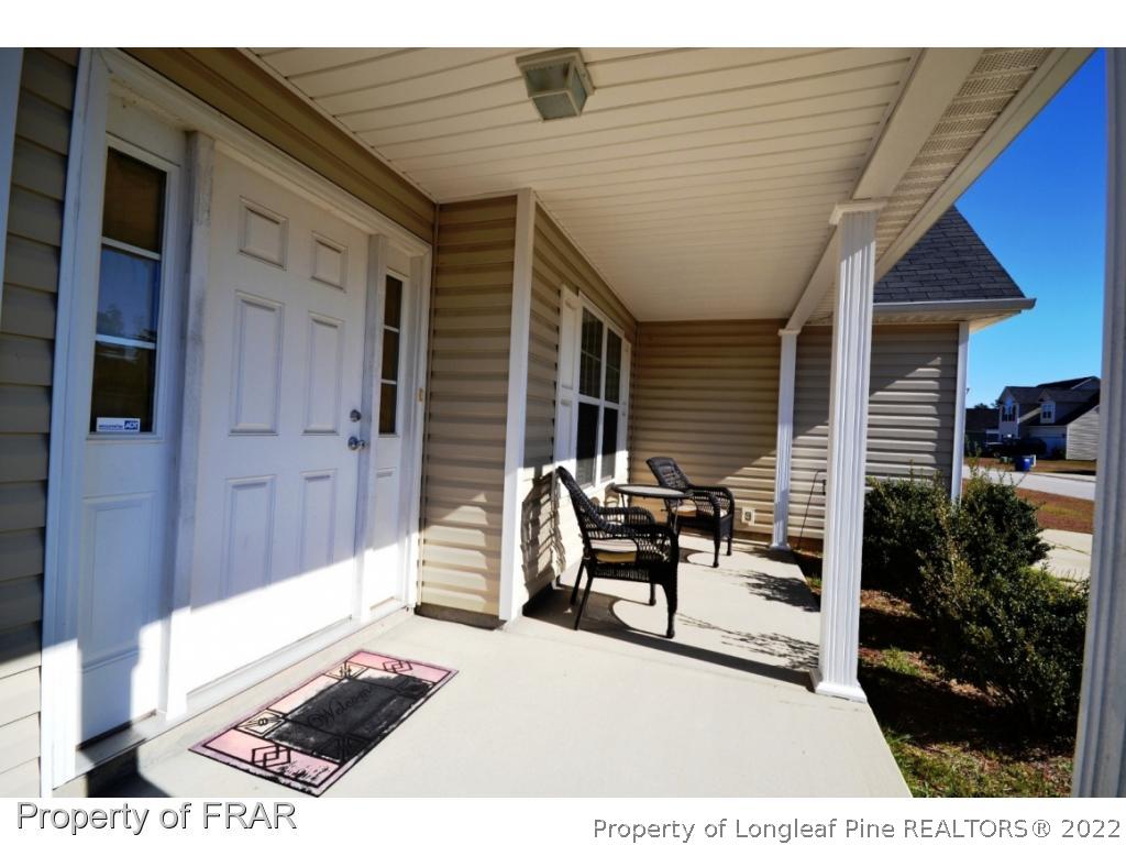 645 Cape Fear Road Raeford, NC 28376 - Photo 2 of 24 a view of a patio with a table and chairs and potted plants