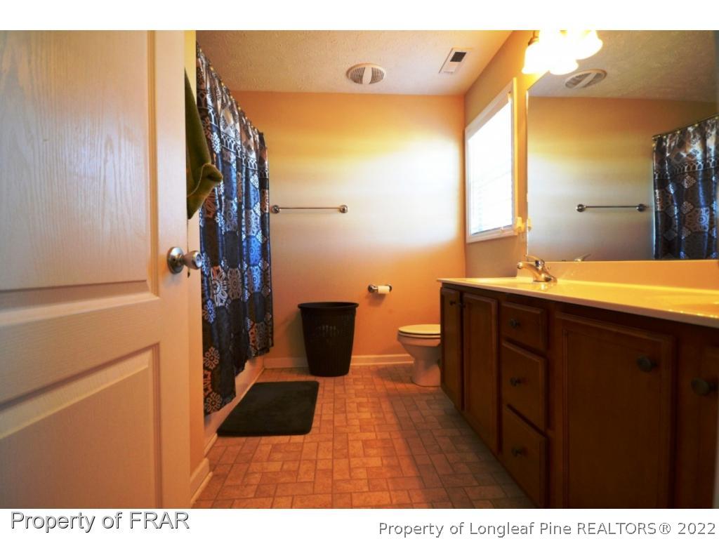 645 Cape Fear Road Raeford, NC 28376 - Photo 21 of 24 a bathroom with a sink and a mirror