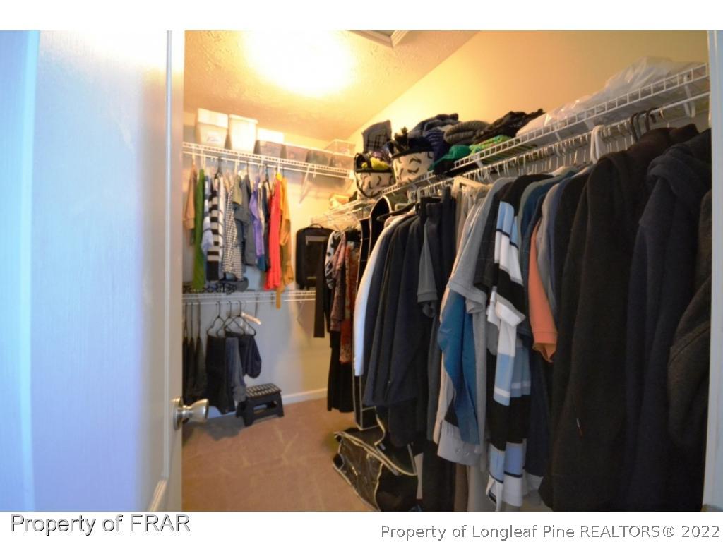 645 Cape Fear Road Raeford, NC 28376 - Photo 22 of 24 a view of walk in closet with clothes and shoes
