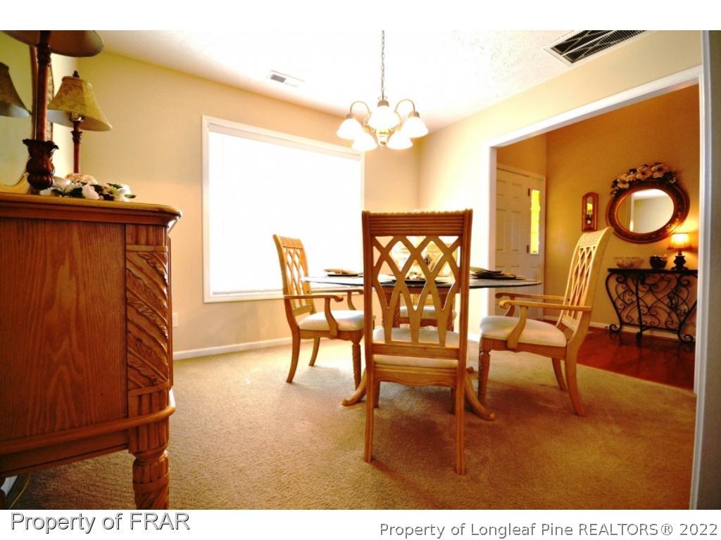 645 Cape Fear Road Raeford, NC 28376 - Photo 4 of 24 a view of a dining room with furniture and wooden floor