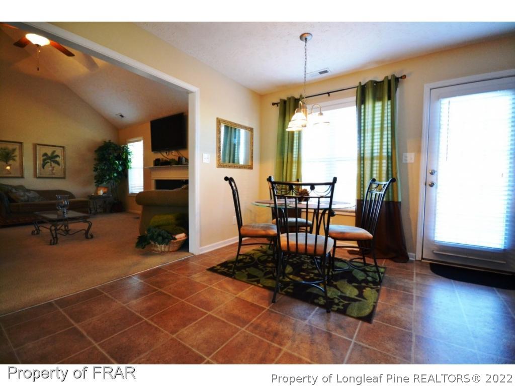 645 Cape Fear Road Raeford, NC 28376 - Photo 8 of 24 a view of a dining room with furniture and wooden floor