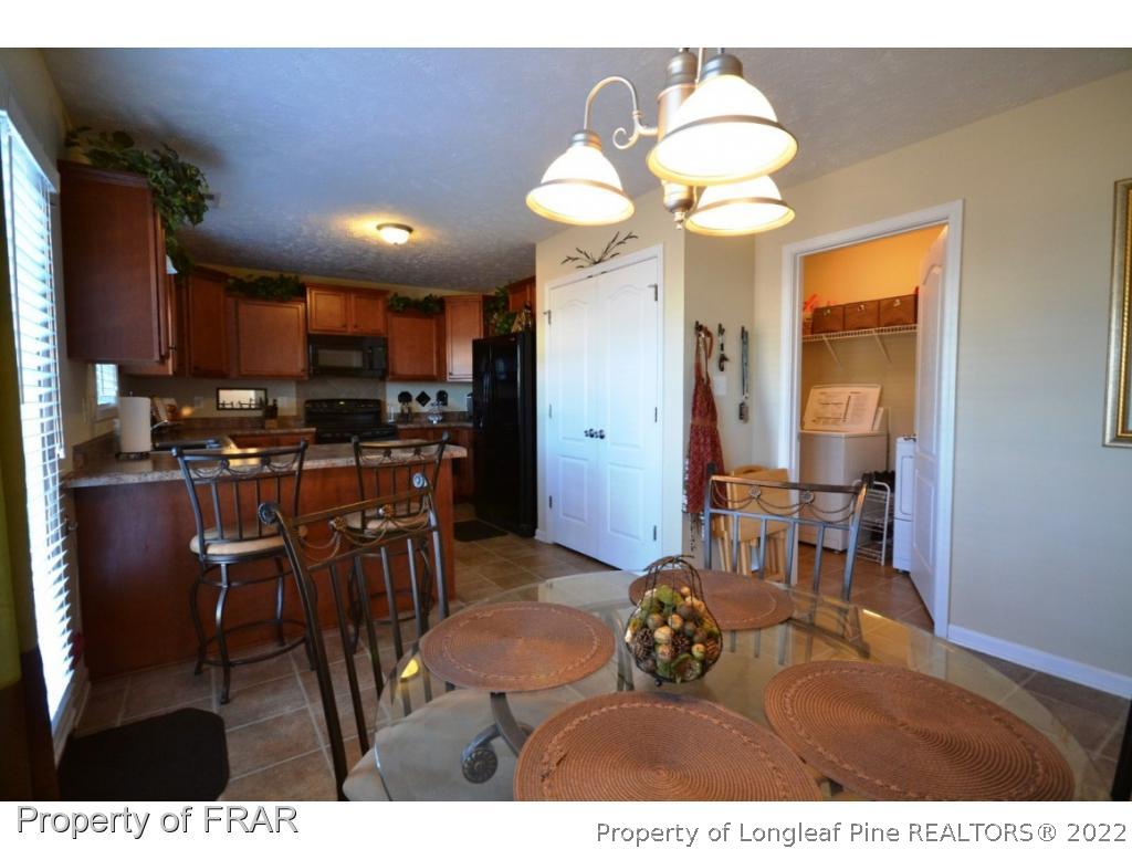 645 Cape Fear Road Raeford, NC 28376 - Photo 10 of 24 a living room with stainless steel appliances kitchen island granite countertop furniture and a large window