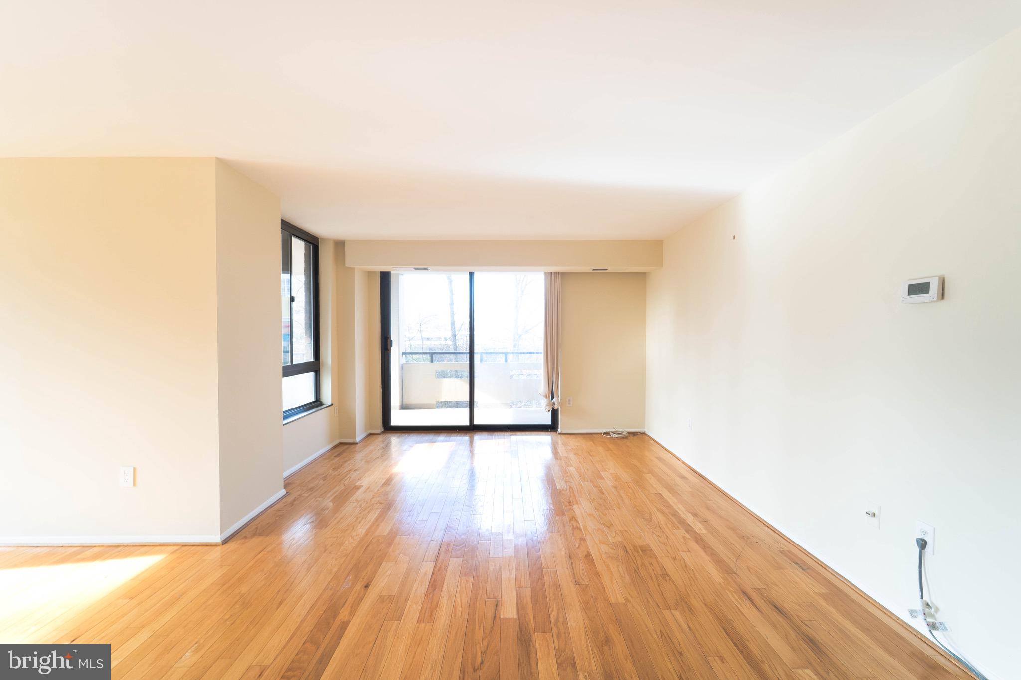 1808 Old Meadow Road, Unit 805 McLean, VA 22102 - Photo 11 of 58 a view of an empty room with wooden floor and a window