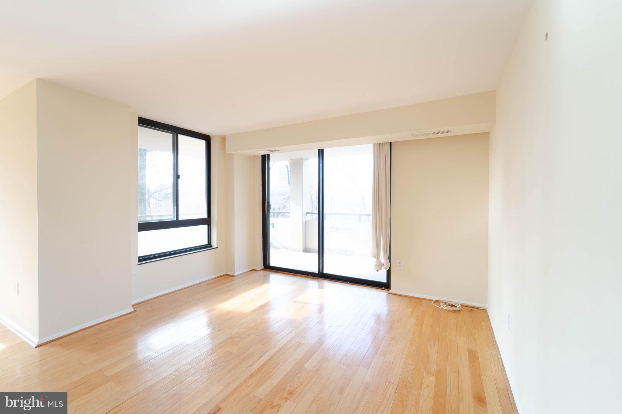 1808 Old Meadow Road, Unit 805 McLean, VA 22102 - Photo 12 of 58 an empty room with wooden floor and windows