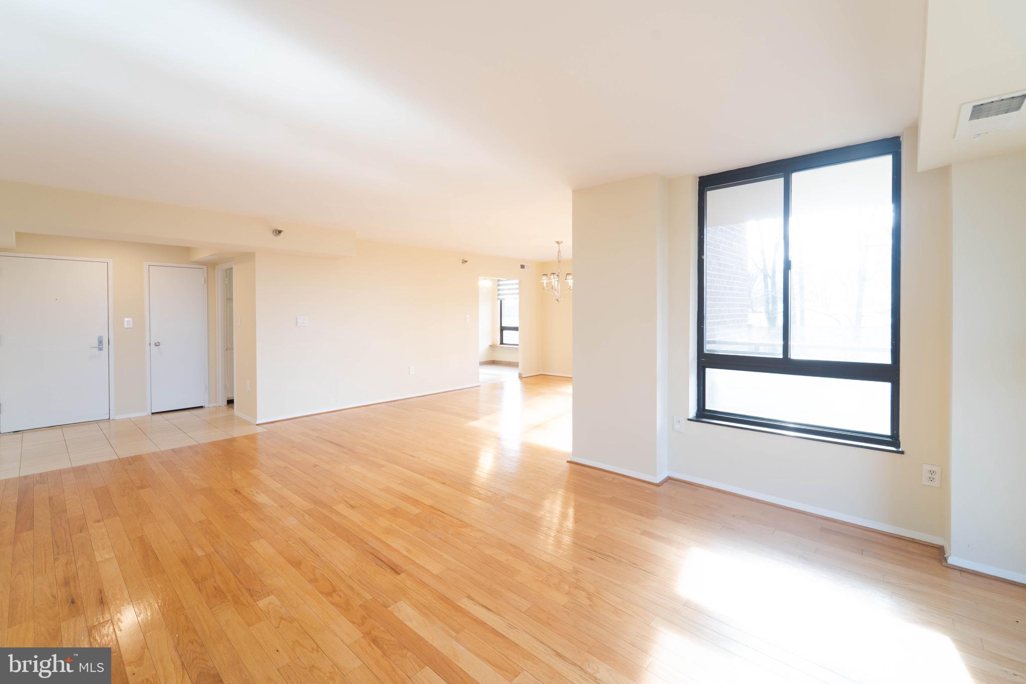 1808 Old Meadow Road, Unit 805 McLean, VA 22102 - Photo 13 of 58 a view of empty room with wooden floor and fan