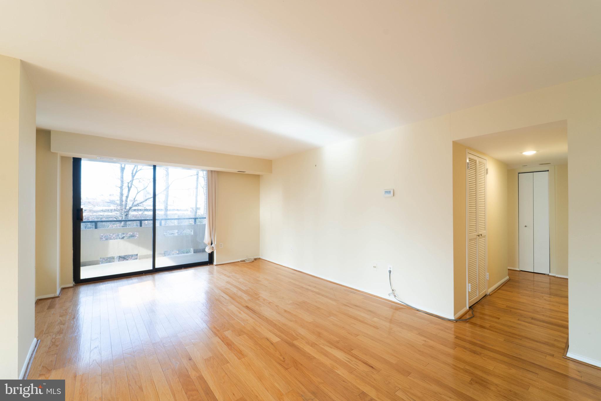 1808 Old Meadow Road, Unit 805 McLean, VA 22102 - Photo 14 of 58 a view of an empty room with wooden floor and a window