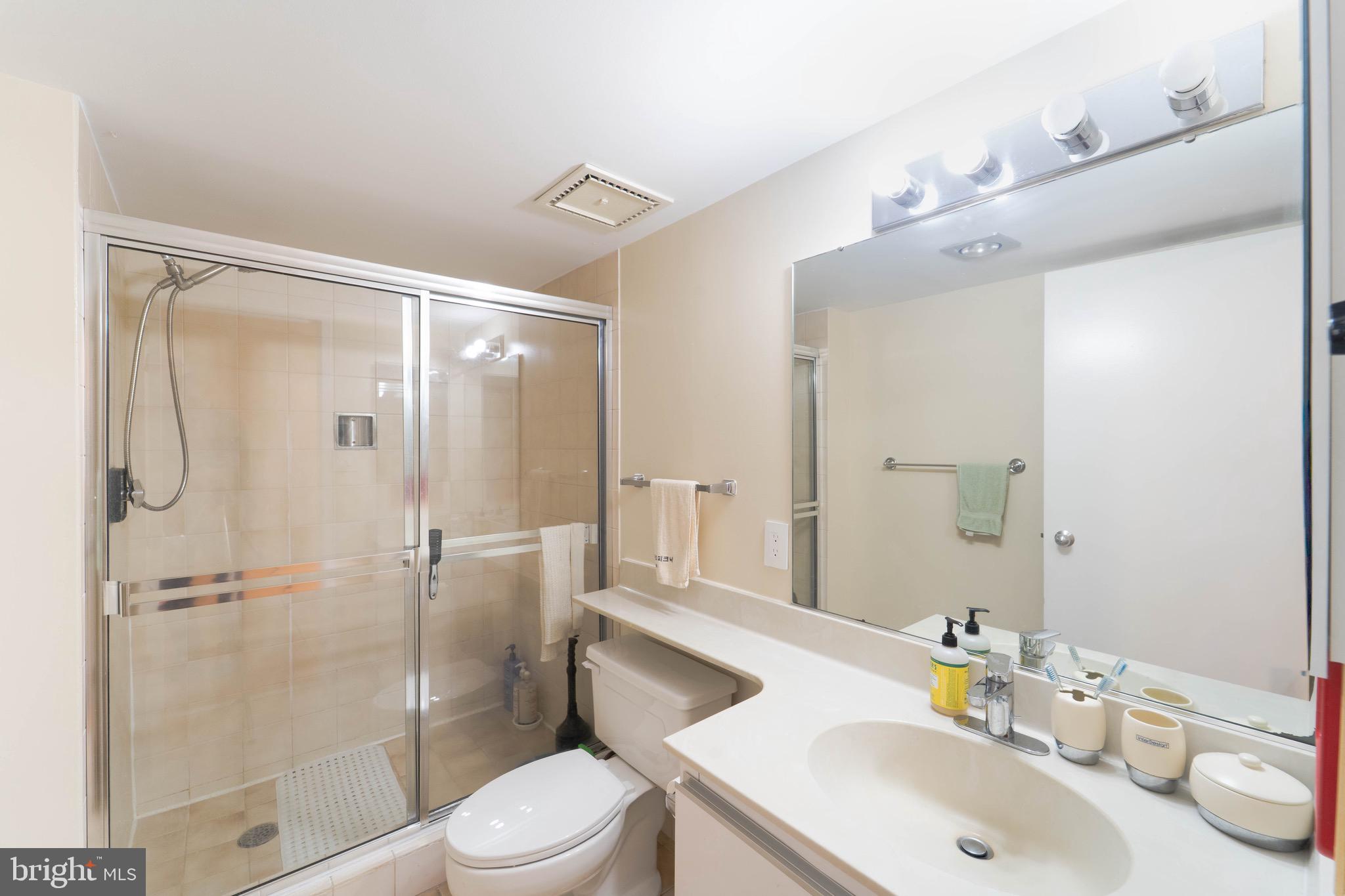 1808 Old Meadow Road, Unit 805 McLean, VA 22102 - Photo 16 of 58 a bathroom with a sink toilet and shower