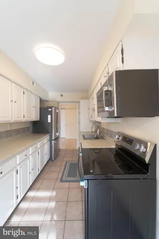 a kitchen that has a sink and a stove